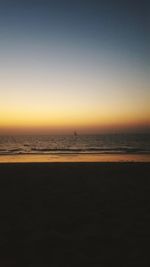 Scenic view of beach against sky during sunset