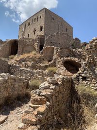 Low angle view of old ruin building against sky