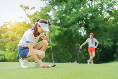 Full length of young woman on golf course