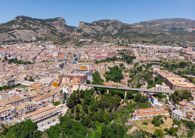 High angle view of buildings in town against clear sky