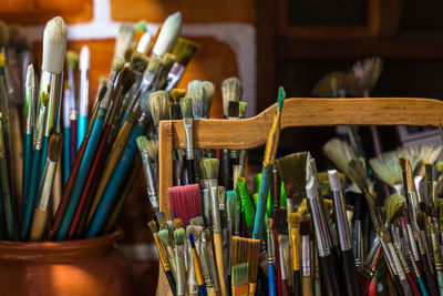 Close-up of paintbrushes in container