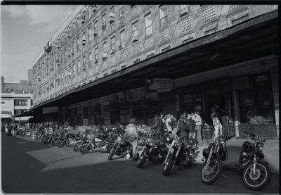 Group of people riding bicycles on road in city