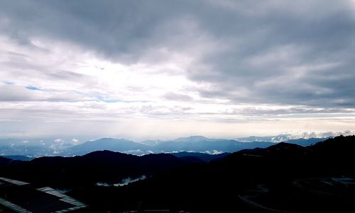 Scenic view of silhouette mountains against sky during sunset