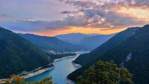 Scenic view of lake against sky during sunset