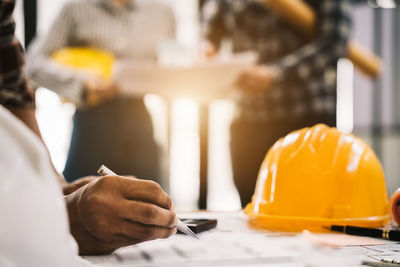 Midsection of architects working at table