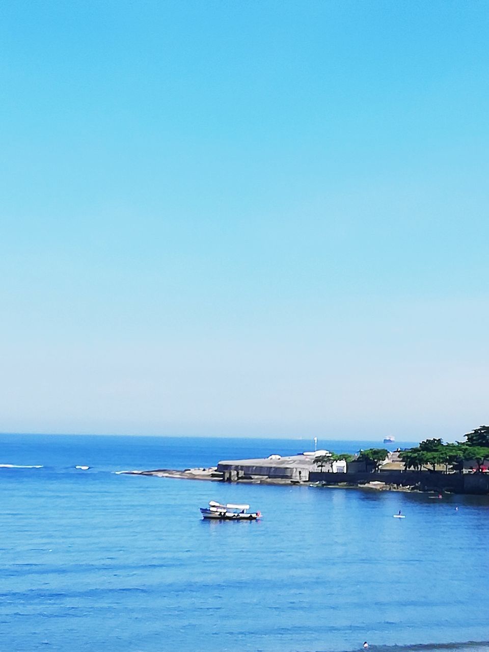 sea, nautical vessel, sky, water, transportation, copy space, mode of transportation, clear sky, scenics - nature, nature, waterfront, beauty in nature, day, blue, no people, horizon, horizon over water, land, outdoors, passenger craft, cruise ship