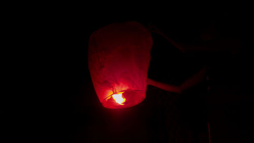 Close-up of illuminated lantern against black background