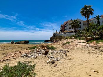 Scenic view of beach against blue sky
