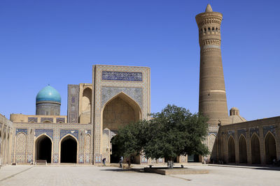 Low angle view of historic building against clear blue sky