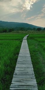 Dirt road along countryside landscape