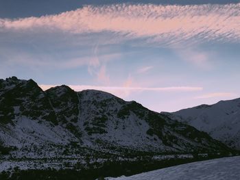 Scenic view of snowcapped mountains against sky during sunset