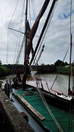 Sailboat moored on sea against sky