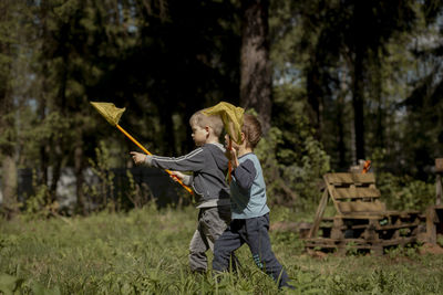 Little boys with butterfly nets in countryside. image with selective focus