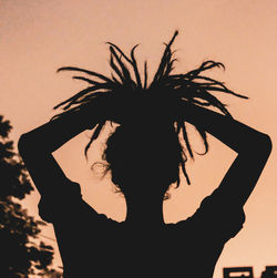 Portrait of silhouette woman standing against sky during sunset