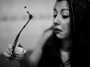 Close-up of young woman with coffee