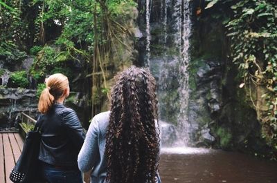 Woman standing on rocks in forest