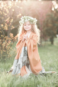 Portrait of girl wearing wreath at park