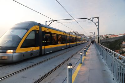 Train at railroad station against sky