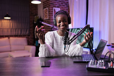 Portrait of female podcasting in studio