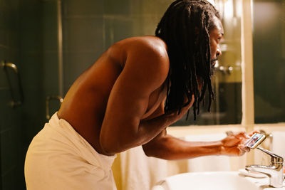 Side view of young woman in bathroom