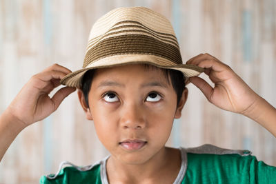 Close-up of boy wearing hat