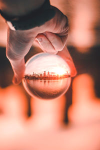 Close-up of hand holding crystal ball