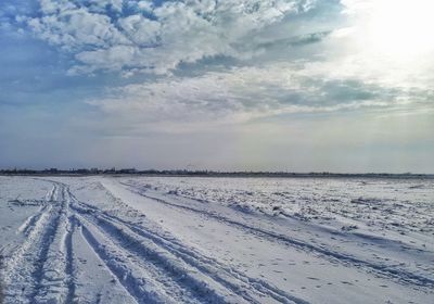 Scenic view of landscape against sky during winter