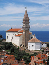 Traditional church by sea against sky