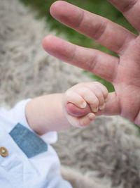 Cropped image of couple holding hands