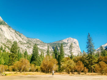 Scenic view of mountains against clear blue sky