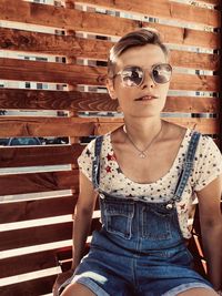 Portrait of woman wearing sunglasses standing outdoors