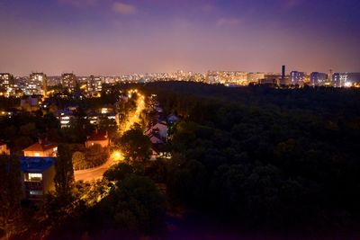 High angle view of illuminated buildings in city at night