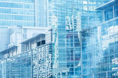 Full frame shot of modern glass building in city