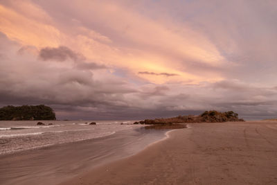 Scenic view of beach against sky during sunset