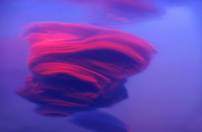 Low angle view of lenticular cloud during sunset