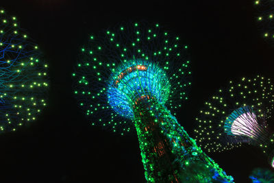 Low angle view of illuminated lights against sky at night
