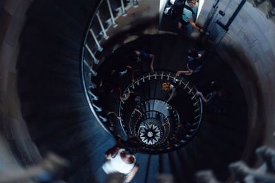 High angle view of people on spiral staircase in building