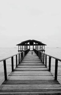 Pier over sea against clear sky