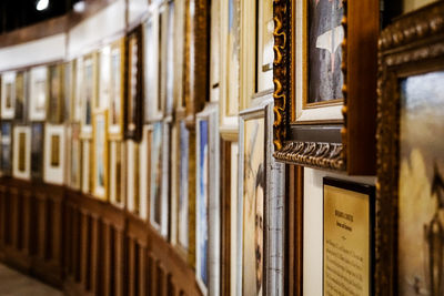 Close-up of wall of paintings in building