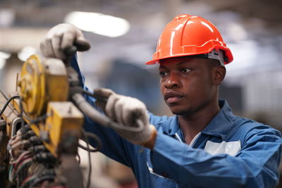 Midsection of man working in factory