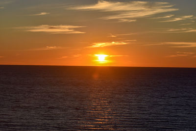 Scenic view of sea against romantic sky at sunset