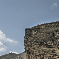 Low angle view of rock formations against sky