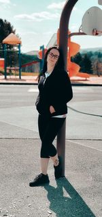 Full length of woman wearing sunglasses standing in city