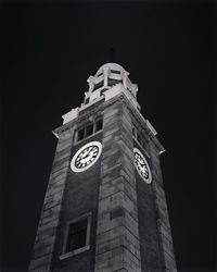 Low angle view of clock tower against building