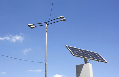 Low angle view of solar panel against blue sky during sunny day