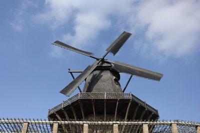 Low angle view of traditional windmill against sky