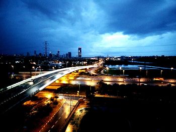 Illuminated city against sky at night