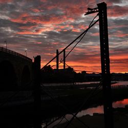 Silhouette of built structure against cloudy sky