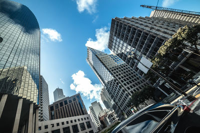 Low angle view of modern buildings in city against sky