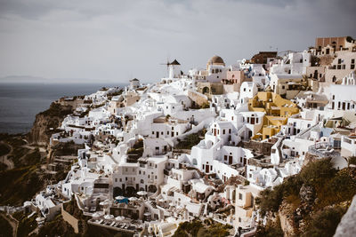 High angle view of buildings by sea against sky